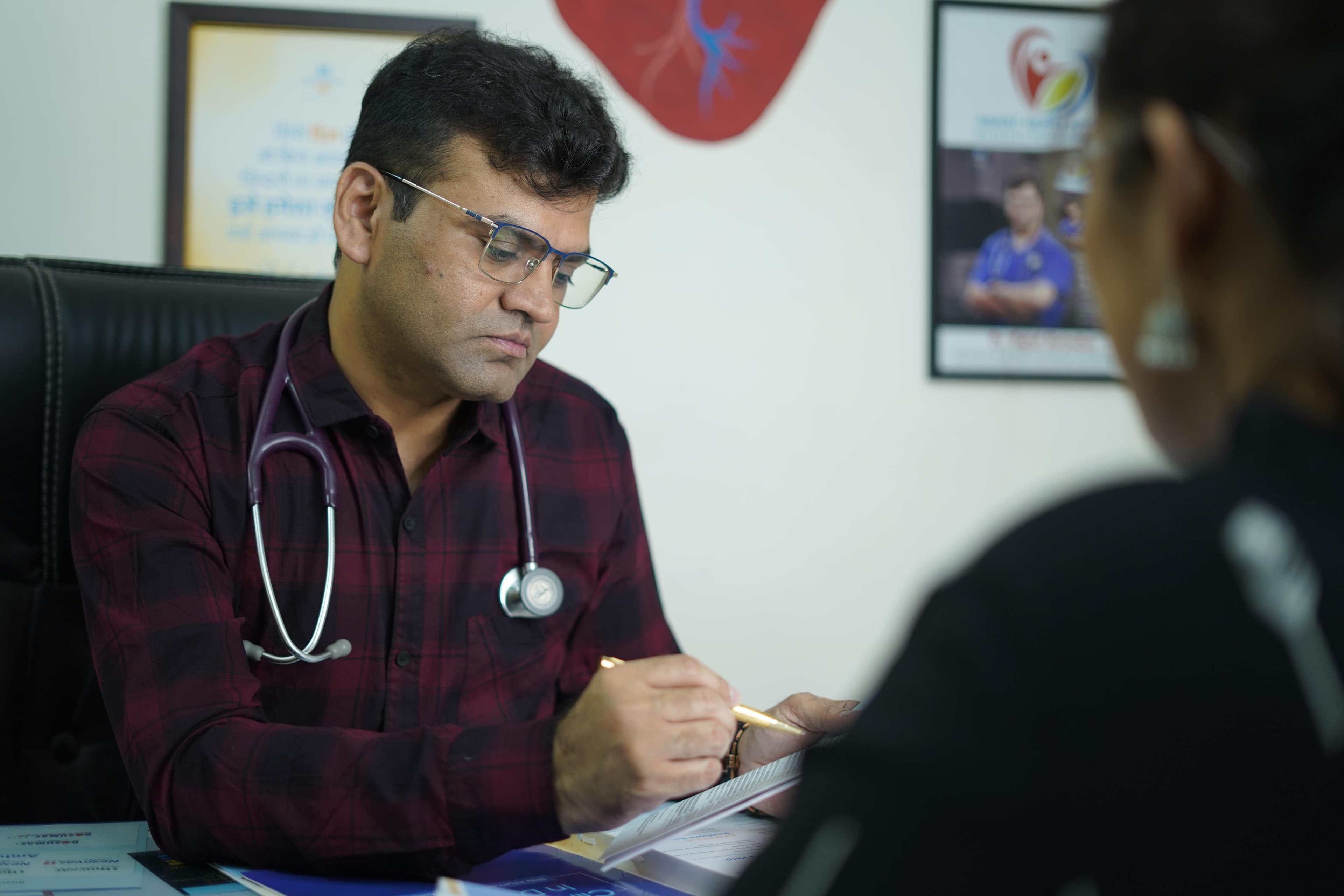 Dr. Brijesh Shrivastava consulting with a patient